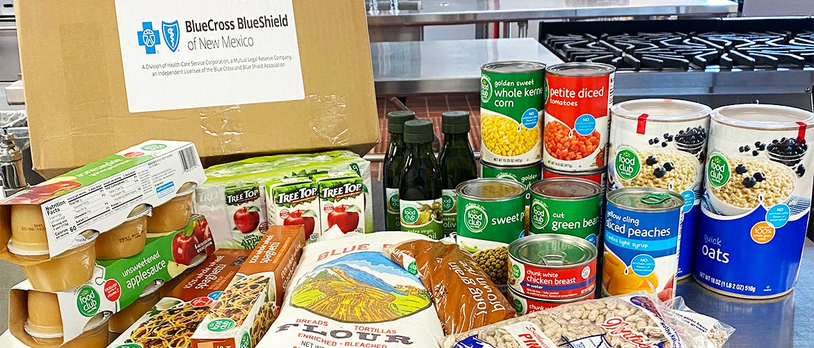 A display of healthy food including canned fruits and vegetables, oats and beans.