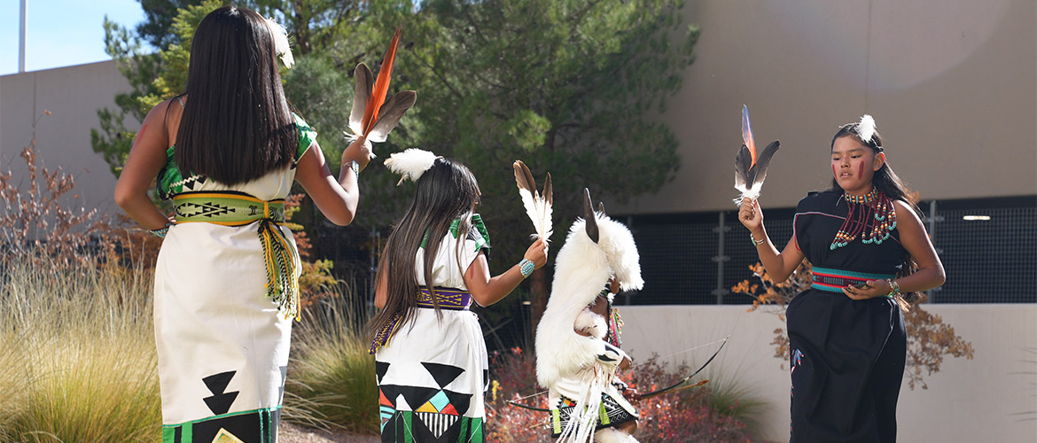 Four Native American women in traditional dress celebrating culture