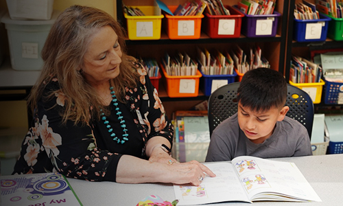 Teacher helps student with homework