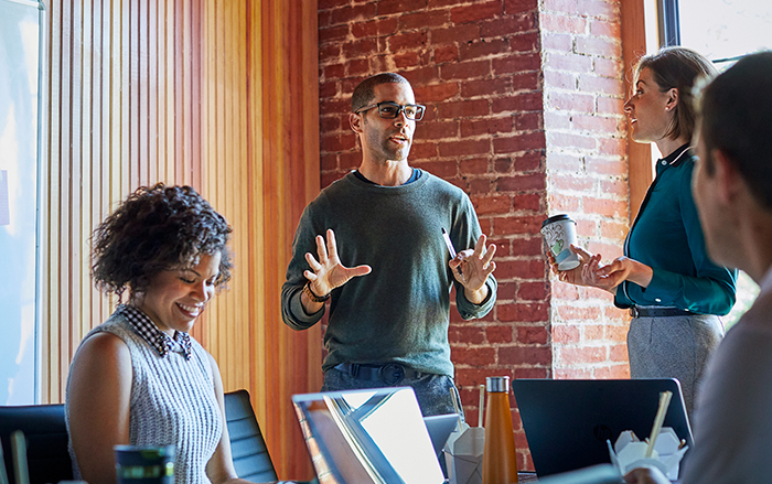 A group of diverse workers collaborating together in office space